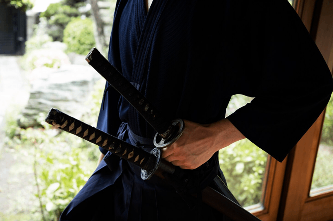 Man practicing how to wear a katana.
