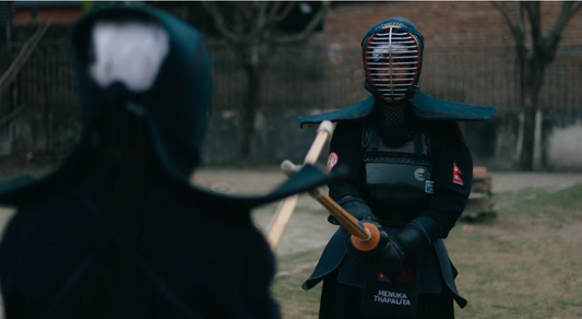 Two people practicing with bokken.