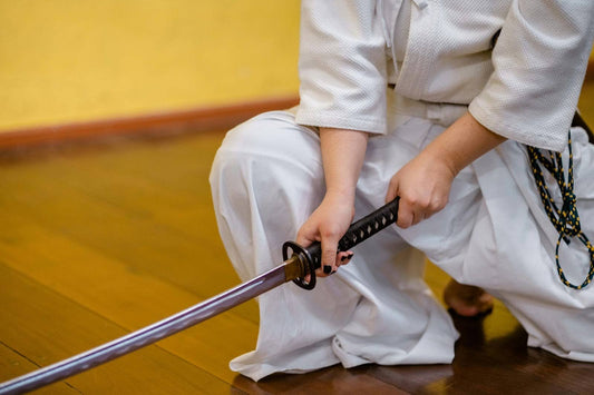 Woman executing beginner katana techniques.