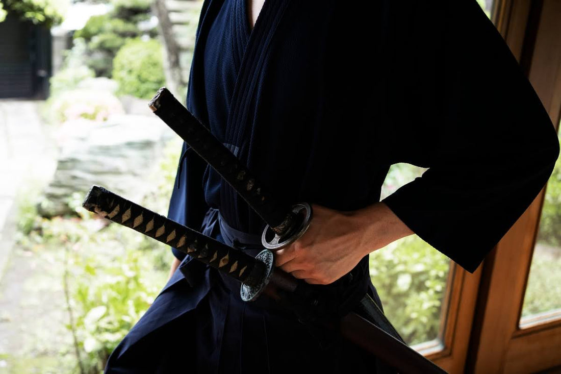 Man with katana and wakizashi samurai swords. 