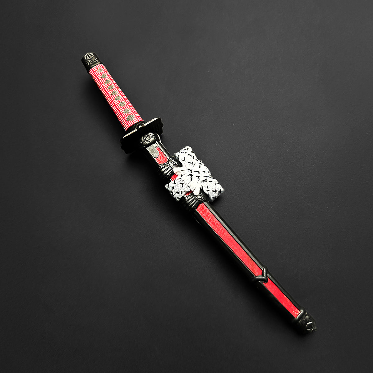 Musashi Swords Mini Katana Mini Samurai Sword Letter Opener with red and black handle and sheath on black background