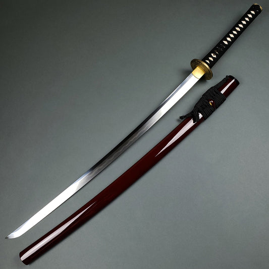 Musashi Tsuru Katana samurai sword with polished blade and black handle next to glossy dark brown scabbard