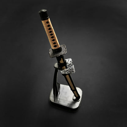 Musashi Swords Mini Katana Mini Samurai Sword Letter Opener with black and tan handle on display stand